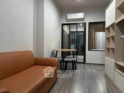 Modern living room with sleek furniture and air conditioning, perfect for urban living.