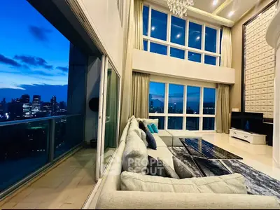 Luxurious high-rise living room with stunning city skyline view and elegant decor.