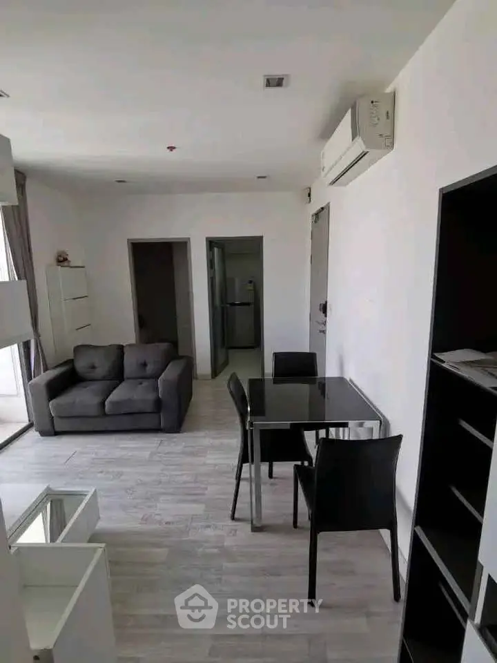 Modern living room with sleek furniture and air conditioning in a stylish apartment.