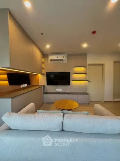 Modern living room with sleek design and ambient lighting