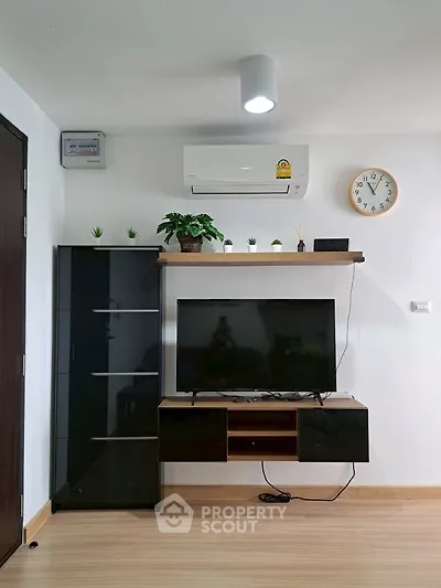 Modern living room with sleek TV unit and air conditioning