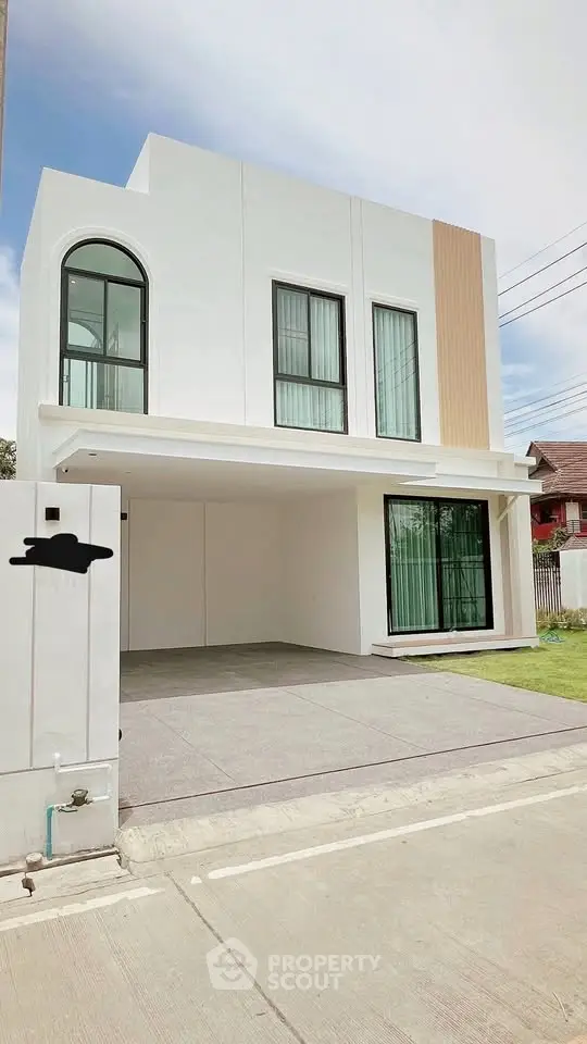 Modern two-story house with sleek design and large windows