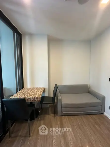 Cozy living room with sofa and dining table in modern apartment