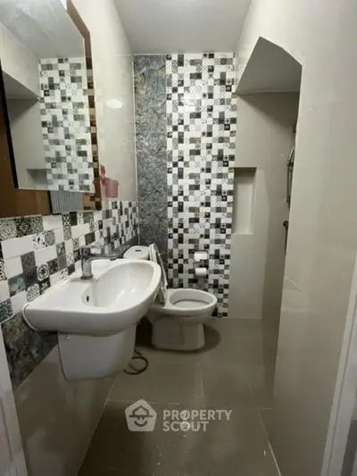 Modern bathroom with stylish tile design and sleek fixtures