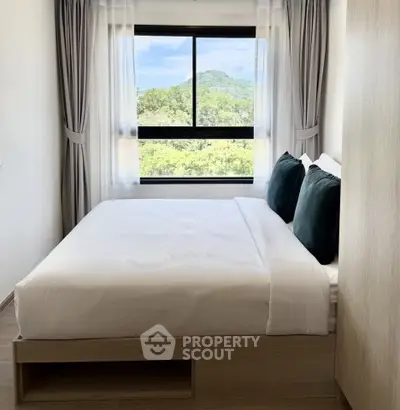 Cozy bedroom with scenic window view and modern decor