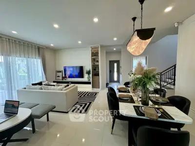 Luxurious open-plan living room with modern decor and elegant dining area