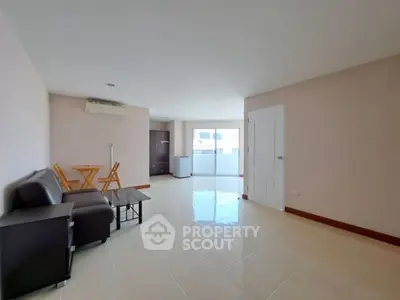 Spacious living room with modern furniture and large windows for natural light.
