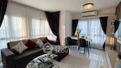 Spacious modern living room with large windows and elegant decor