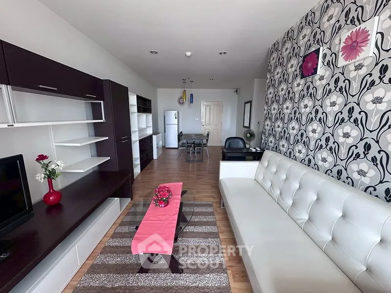 Stylish modern living room with floral accent wall and sleek furniture
