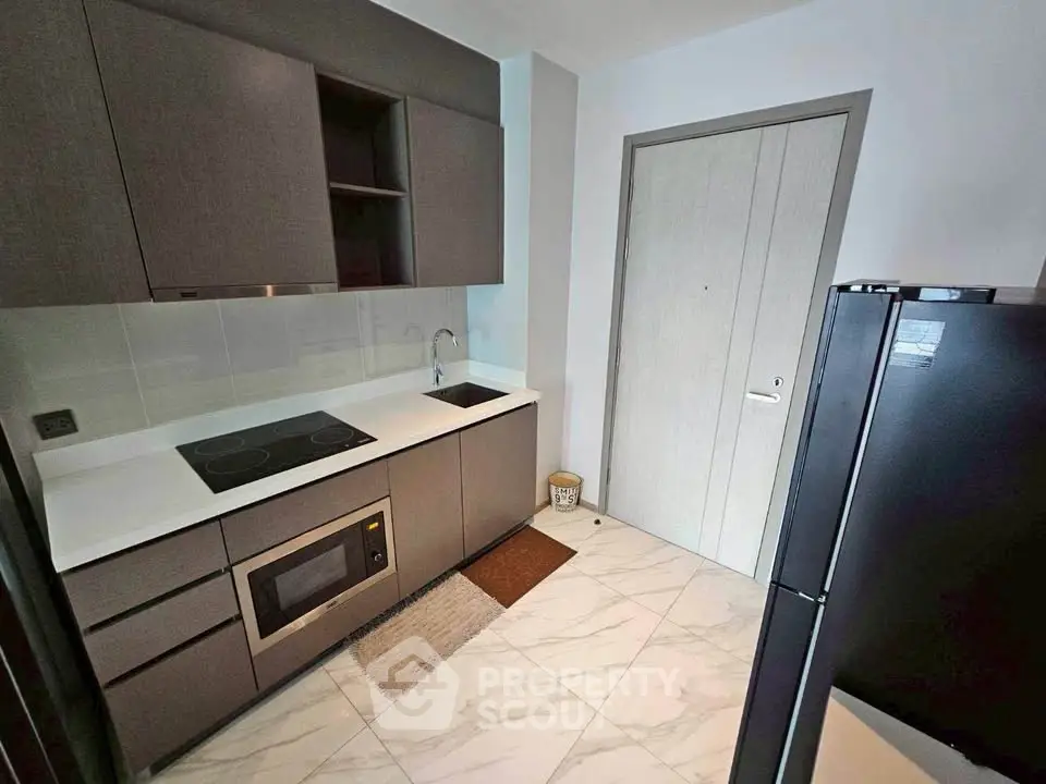 Modern kitchen with sleek cabinetry and built-in appliances in a stylish apartment.