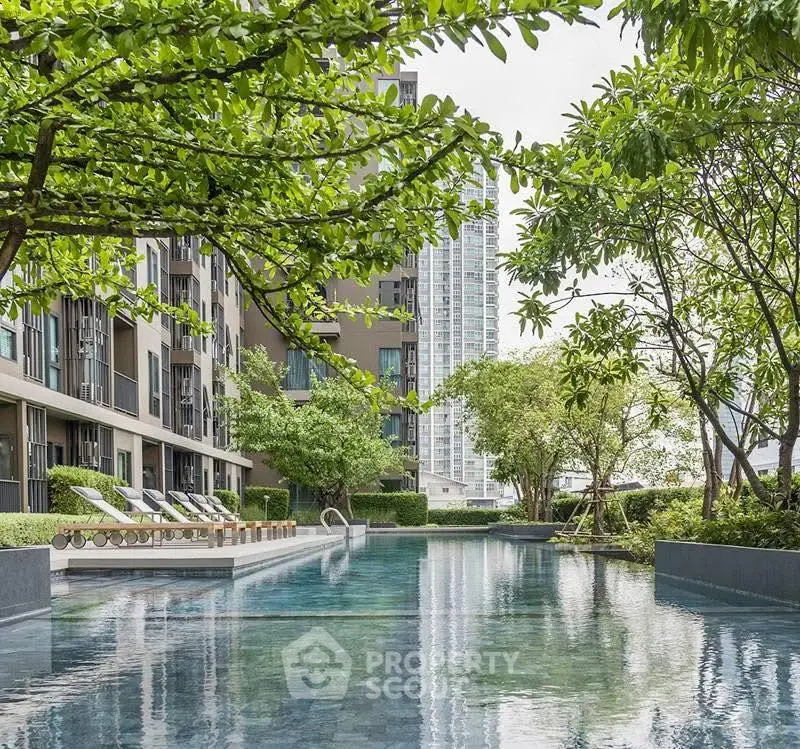 Luxurious modern apartment pool surrounded by lush greenery and cityscape views.