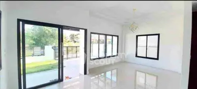 Spacious modern living room with large windows and garden view
