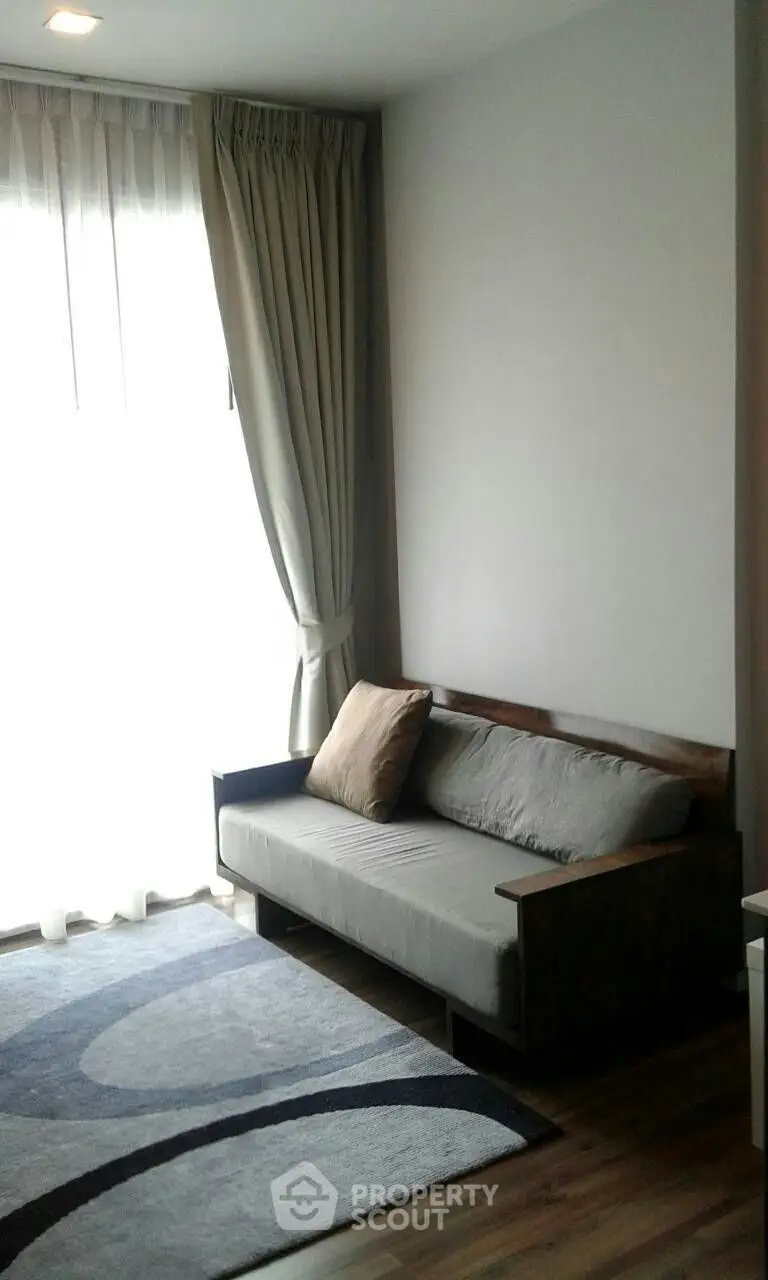 Cozy living room with modern sofa and elegant curtains, perfect for relaxation.