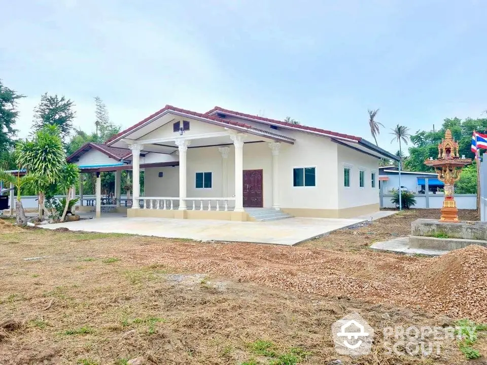 Charming single-story house with spacious front yard and traditional architectural elements.