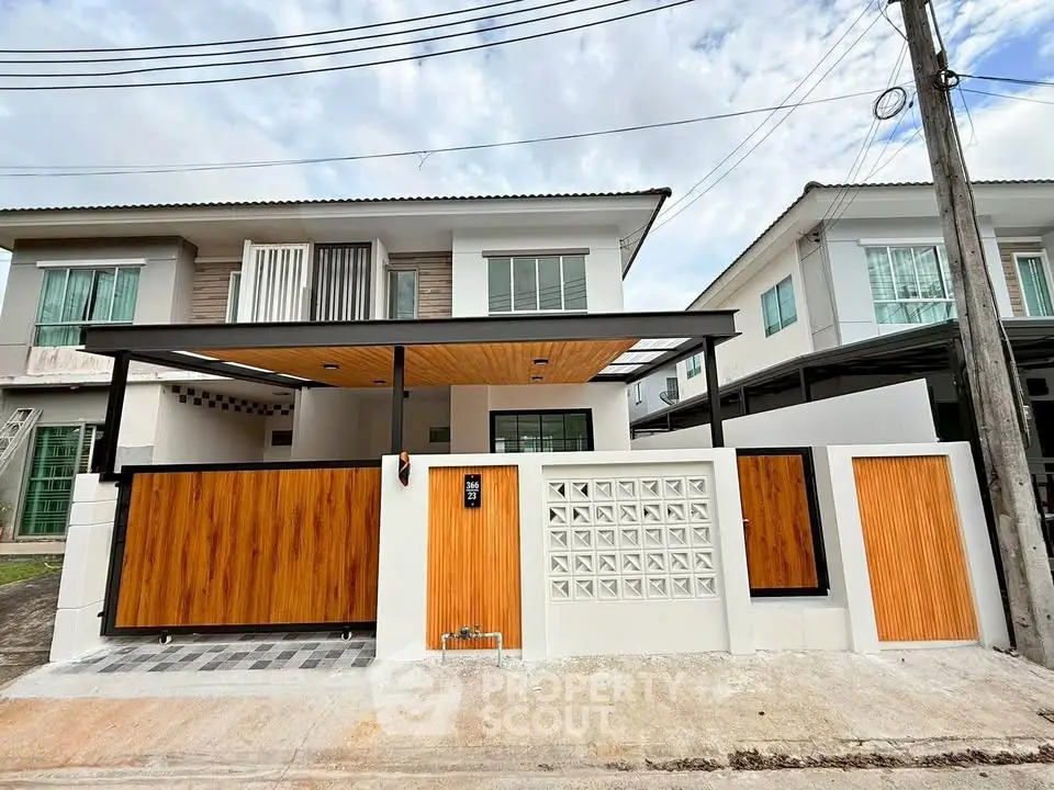Modern two-story house with wooden accents and gated entrance
