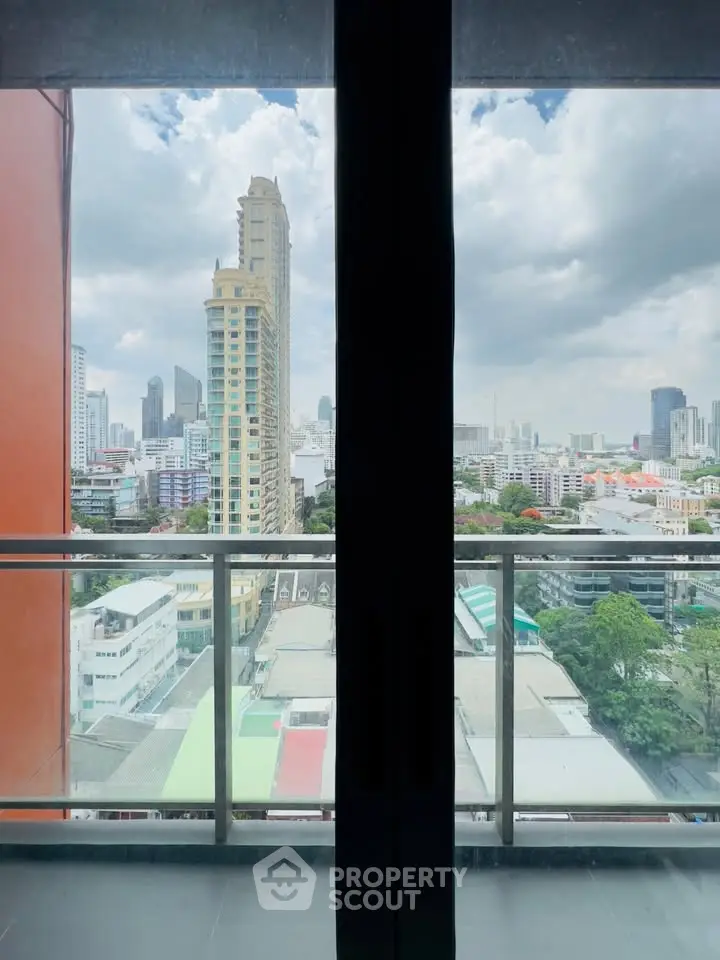 Stunning cityscape view from a high-rise balcony with modern skyline.