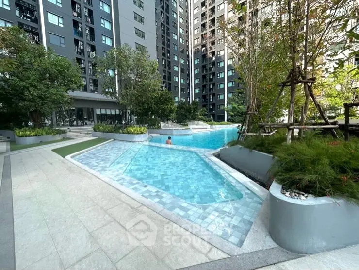 Luxurious residential complex with a stunning outdoor pool and lush greenery.