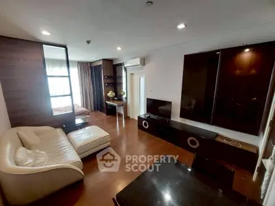 Spacious modern living room with sleek furniture and hardwood floors in a stylish apartment.