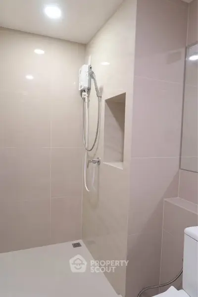 Modern bathroom with sleek shower design and neutral tiles