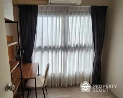 Cozy study room with natural light and elegant curtains