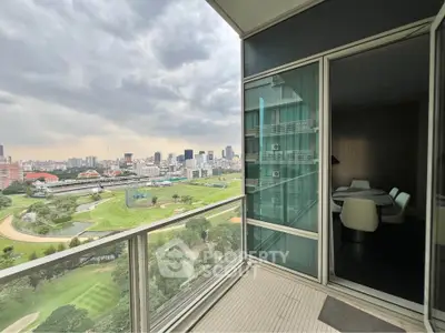 Stunning high-rise balcony with panoramic city and golf course views, perfect for urban living.