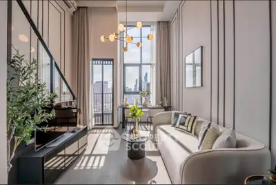 Luxurious modern living room with high ceilings and city view, featuring elegant decor and ample natural light.