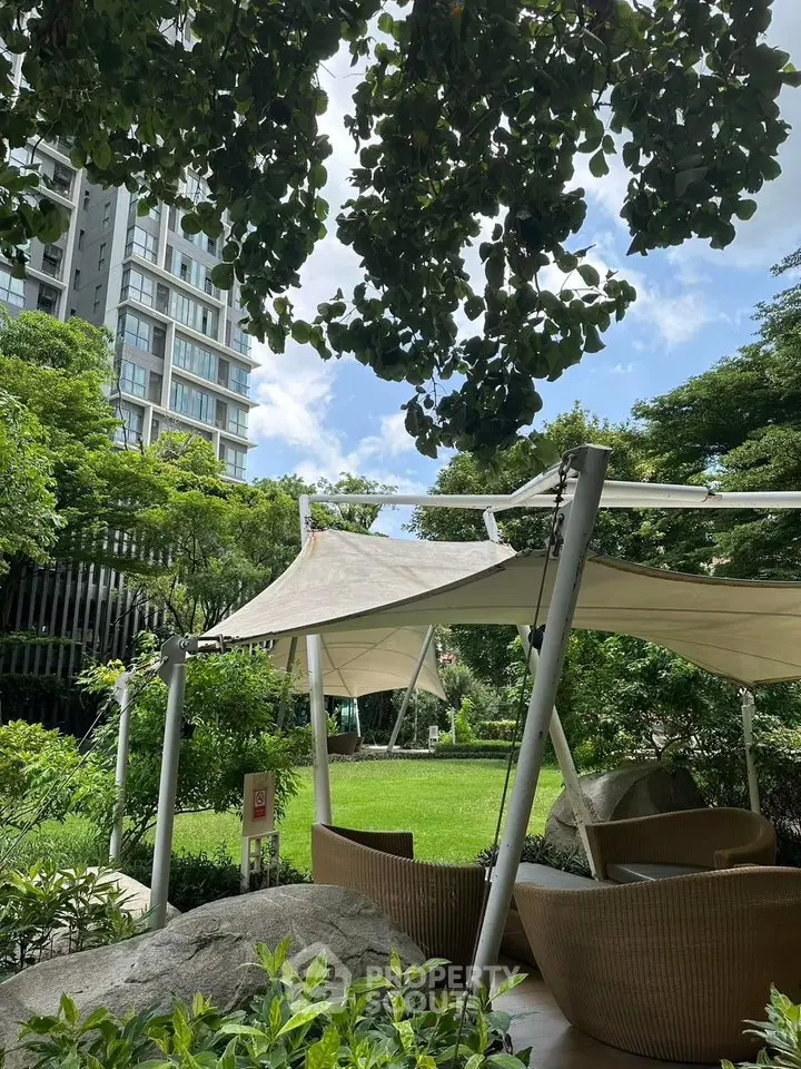 Luxurious garden with modern canopy seating in urban residential complex