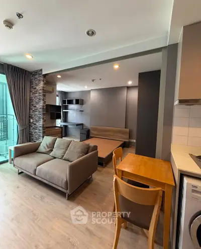 Modern studio apartment with open layout, featuring cozy living area and compact kitchen.
