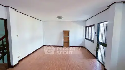 Spacious empty living room with wooden flooring and natural light