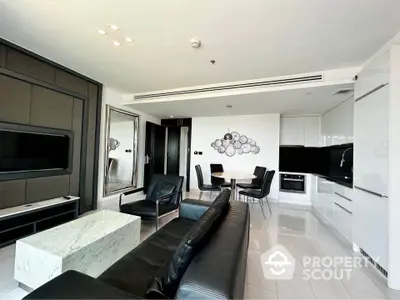 Modern living room with sleek black and white decor, open kitchen layout, and elegant dining area.