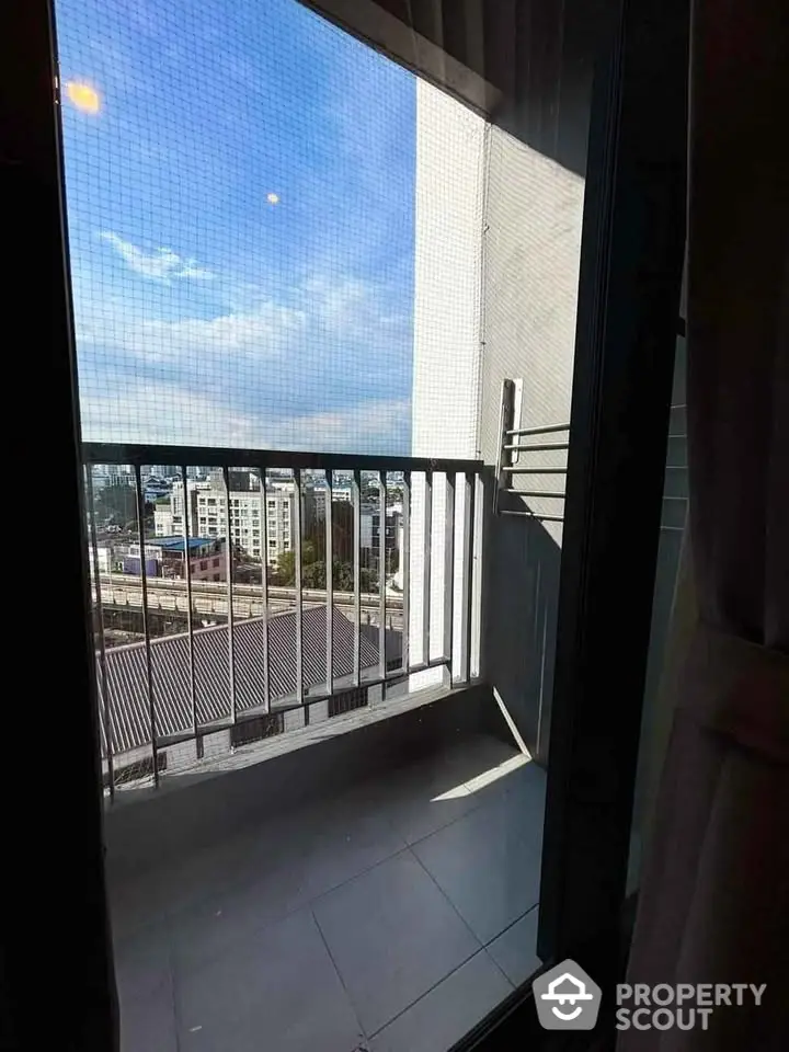 Charming small balcony with city view, perfect for relaxation and enjoying the skyline.