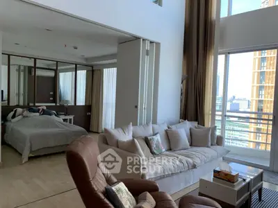 Spacious modern living room with large windows and city view, featuring cozy seating and elegant decor.