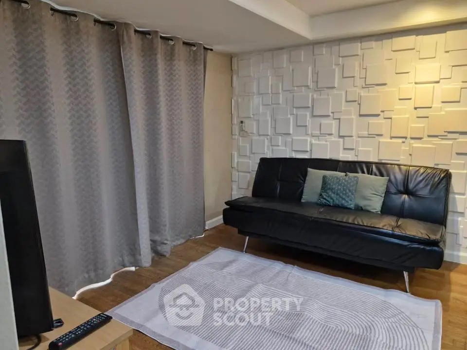 Modern living room with stylish wall design and cozy seating area.