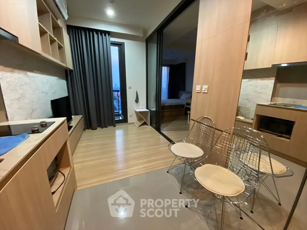 Modern apartment interior with open layout, featuring stylish kitchen and cozy living area.