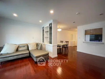 Spacious living room with elegant hardwood floors and cozy seating area