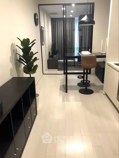 Modern apartment interior with sleek kitchen and stylish dining area, featuring contemporary decor and open layout.