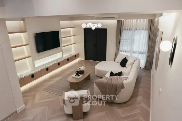 Modern living room with stylish furniture and built-in shelving