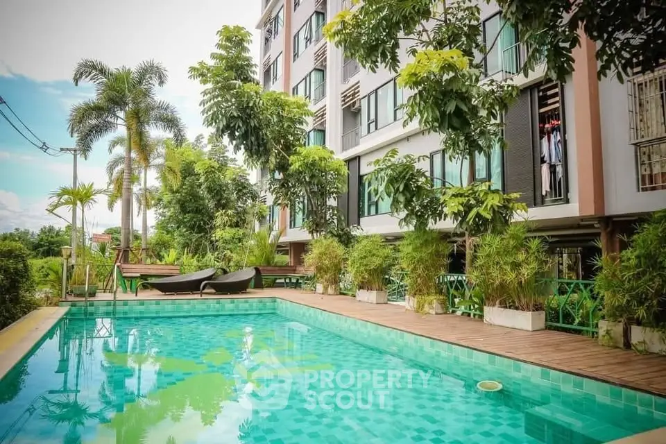 Luxurious apartment complex with a stunning outdoor pool and lush greenery, perfect for relaxation and leisure.