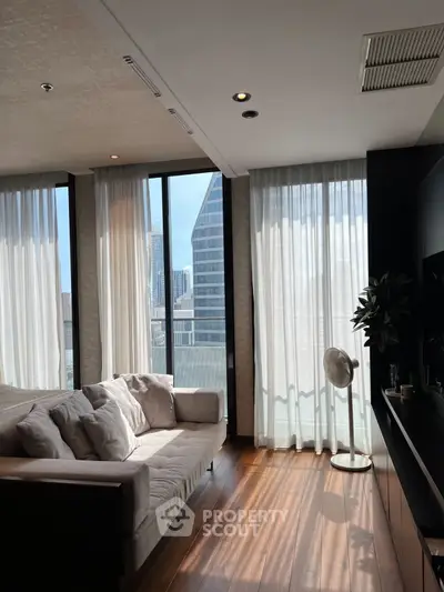 Luxurious living room with floor-to-ceiling windows and stunning city view