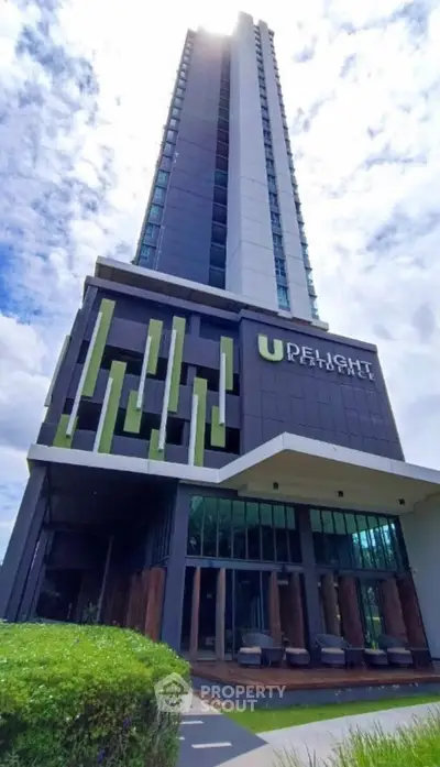 Modern high-rise building with unique architectural design and lush greenery.
