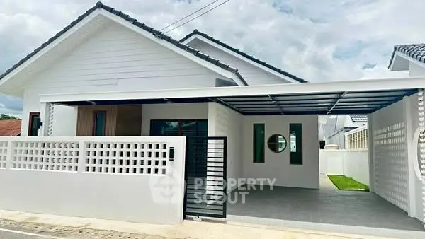 Modern single-story house with carport and white facade