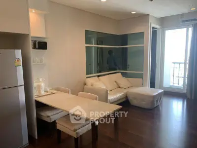 Modern living room with dining area and balcony access in a stylish apartment.