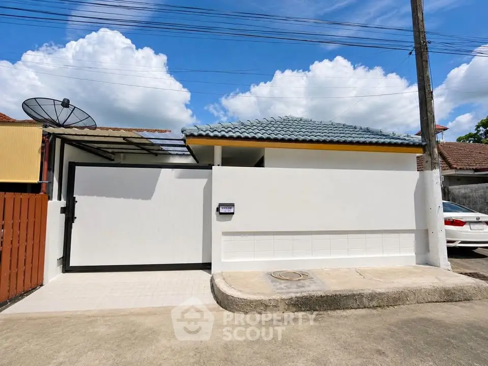 Charming single-story home with tiled roof and gated entrance, perfect for modern living.