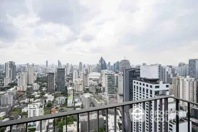 Stunning city skyline view from high-rise balcony in urban real estate setting.