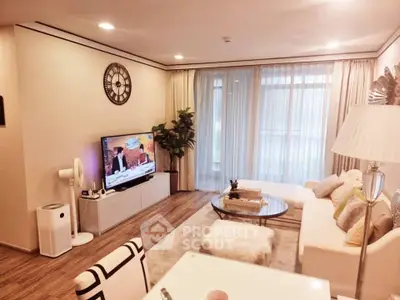 Stylish modern living room with cozy seating and large TV, perfect for relaxation.