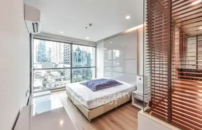 Modern bedroom with city view, featuring large windows and stylish decor in urban apartment.