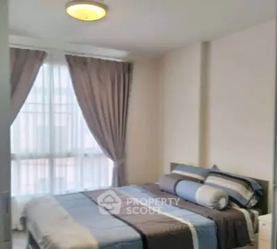 Cozy bedroom with large window and elegant curtains in modern apartment.