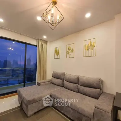 Modern living room with stylish gray sofa and city view, perfect for urban living.