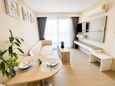 Modern living room with elegant decor, large window, and cozy seating area in a stylish apartment.