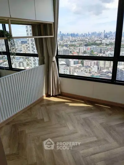 Stunning city view from modern apartment with large windows and elegant flooring.